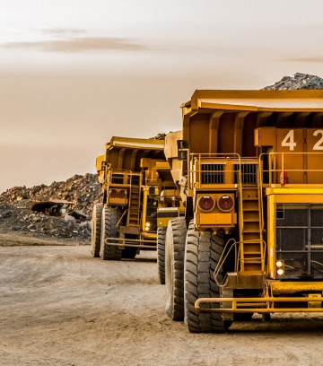 Large-mining-rock-dump-trucks-transporting-Platinum-ore-for-processing-936418814_2124x1416-900